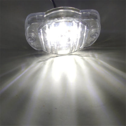 Clear LED light bulb on a reflective surface with a dark background